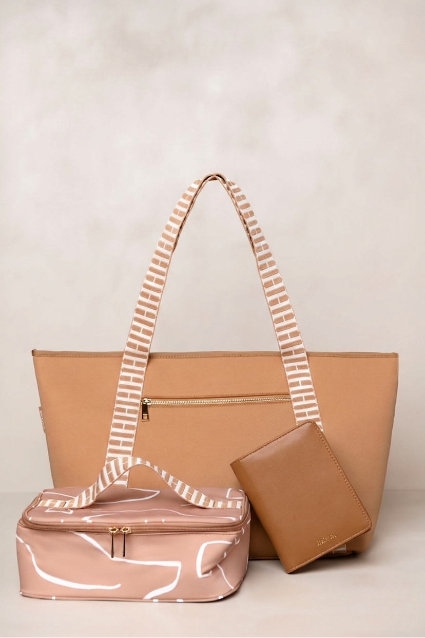 Tan handbag with custom handle and matching wallet on a light background for travel