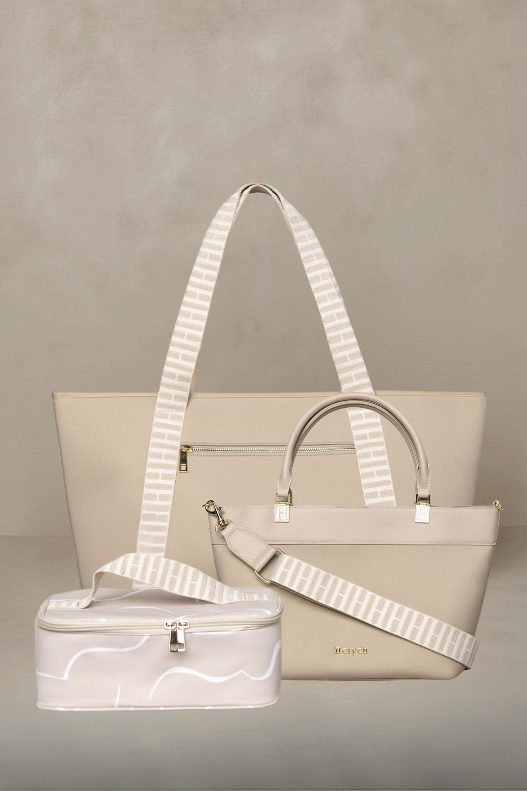 Beige taupe handbag with a matching small suitcase on a gray background