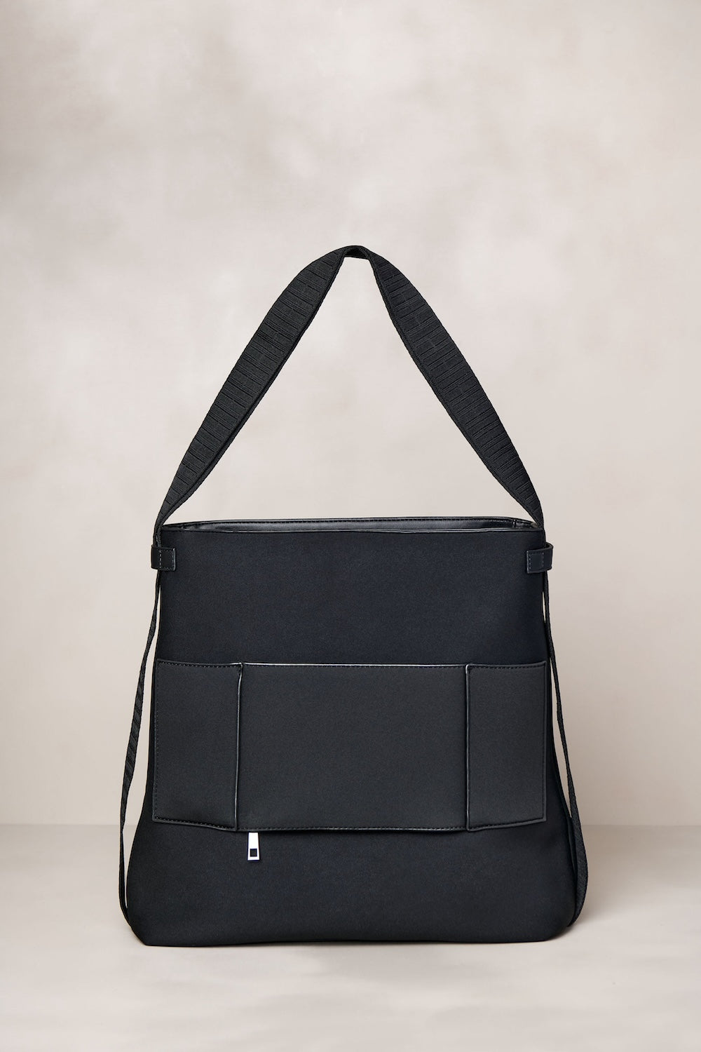 Black convertible tote backpack bag in neoprene with gunmetal hardware
