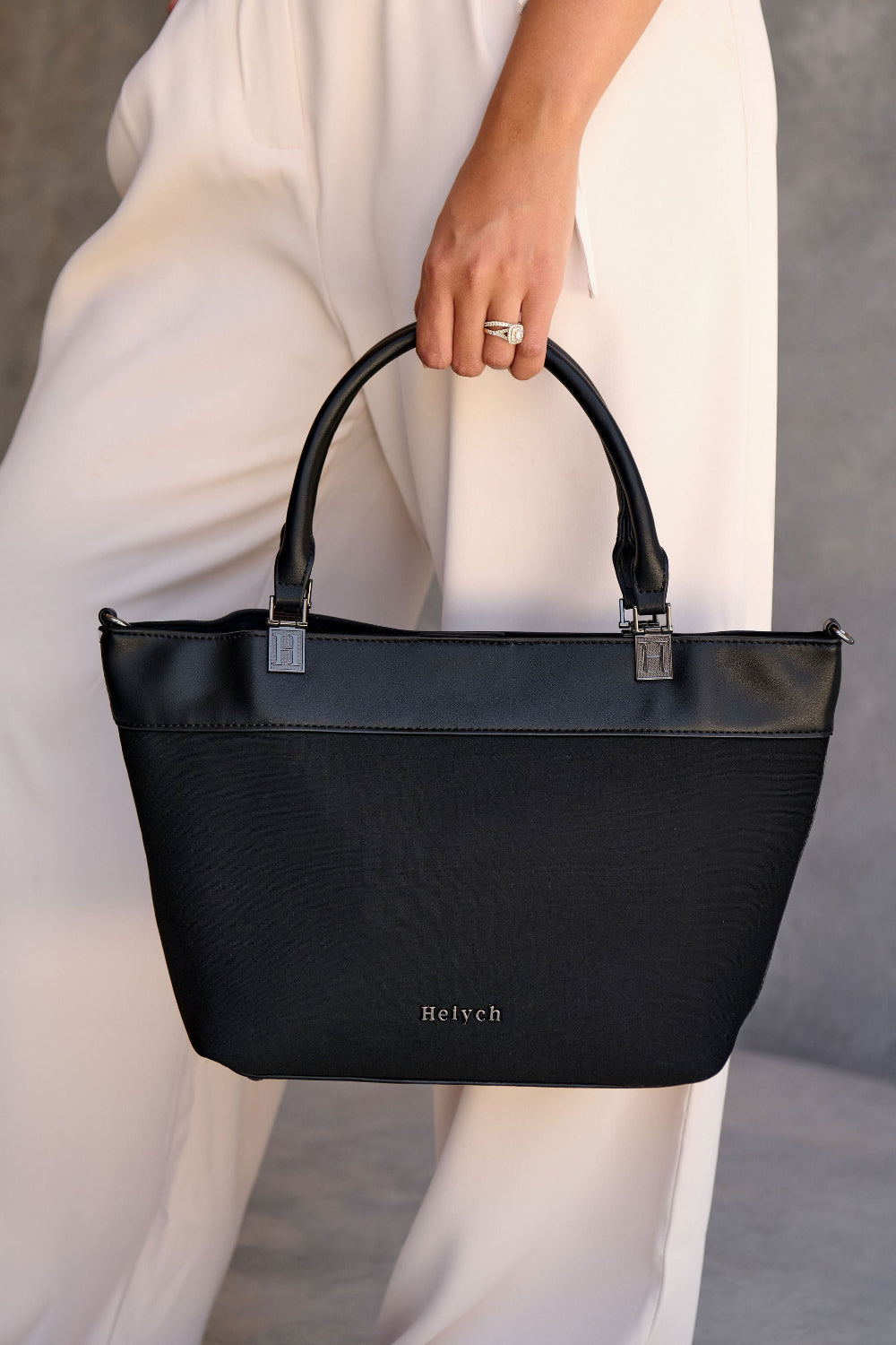 Black neoprene crossbody tote bag with handle and adjustable strap