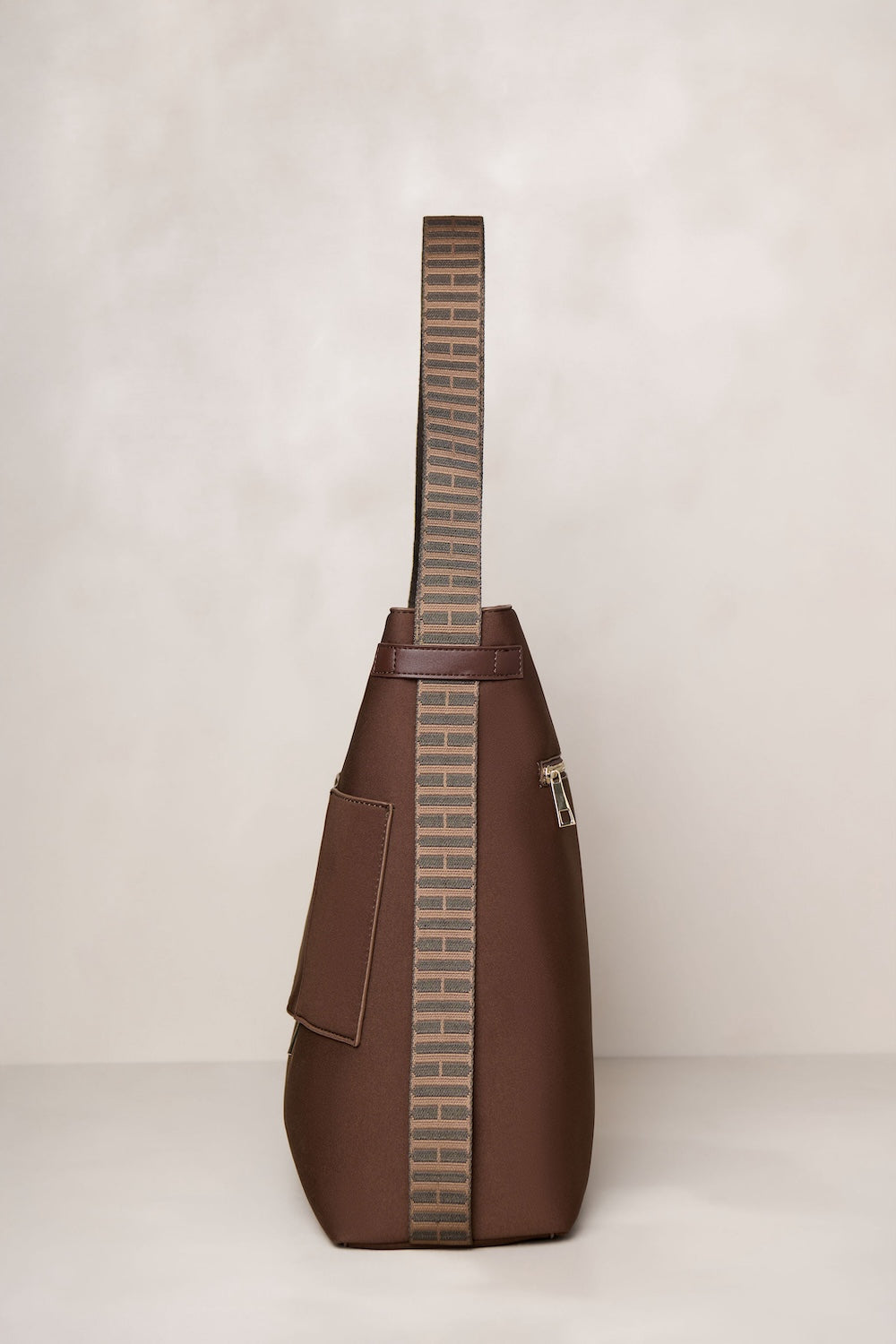 Chocolate brown convertible tote backpack bag in neoprene with gold hardware side view