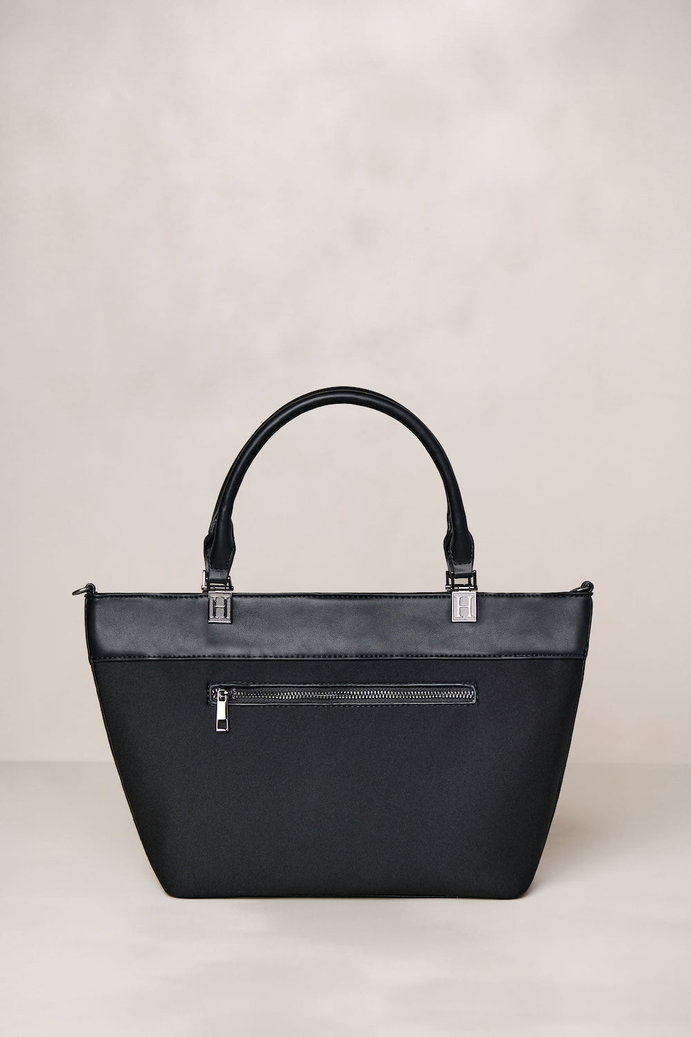 Black handbag on a light beige background