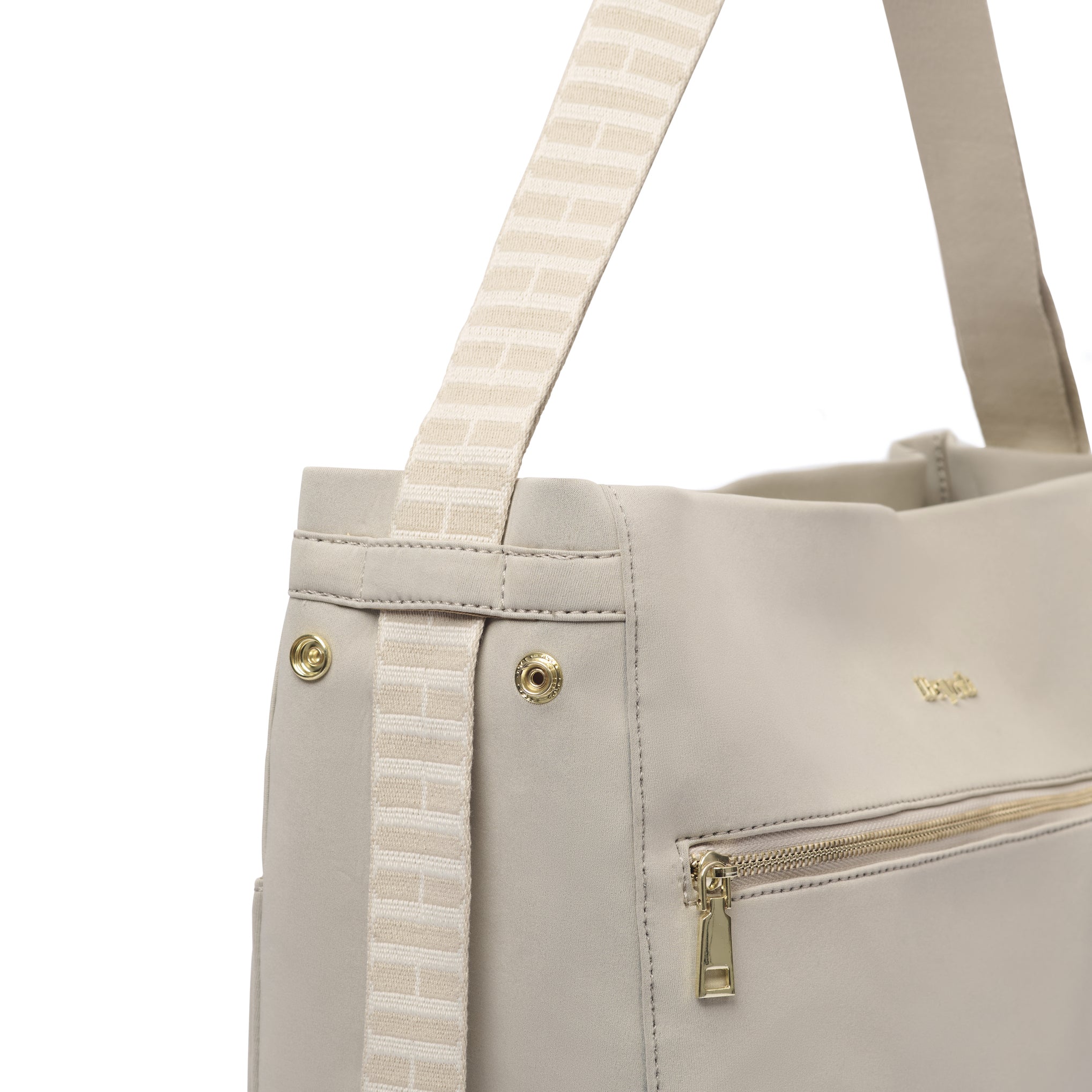 Close up of side of tote to backpack bag showing how it can convert as a 2-in-1 bag by pulling the side straps.