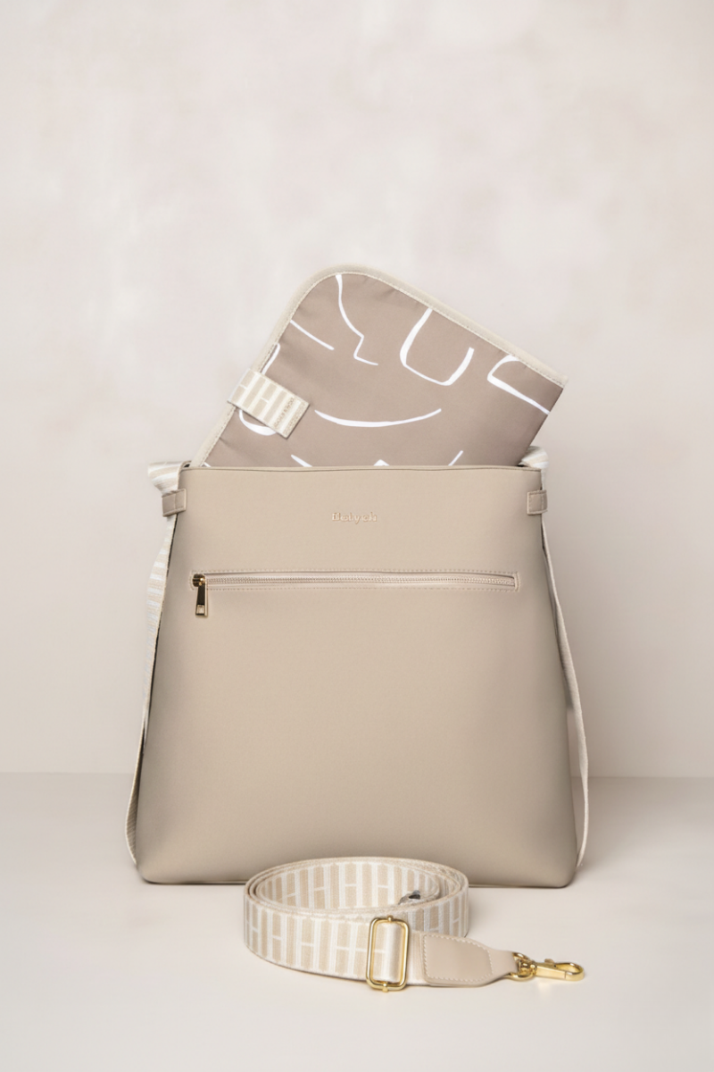 Taupe backpack and crossbody strap on a light background
