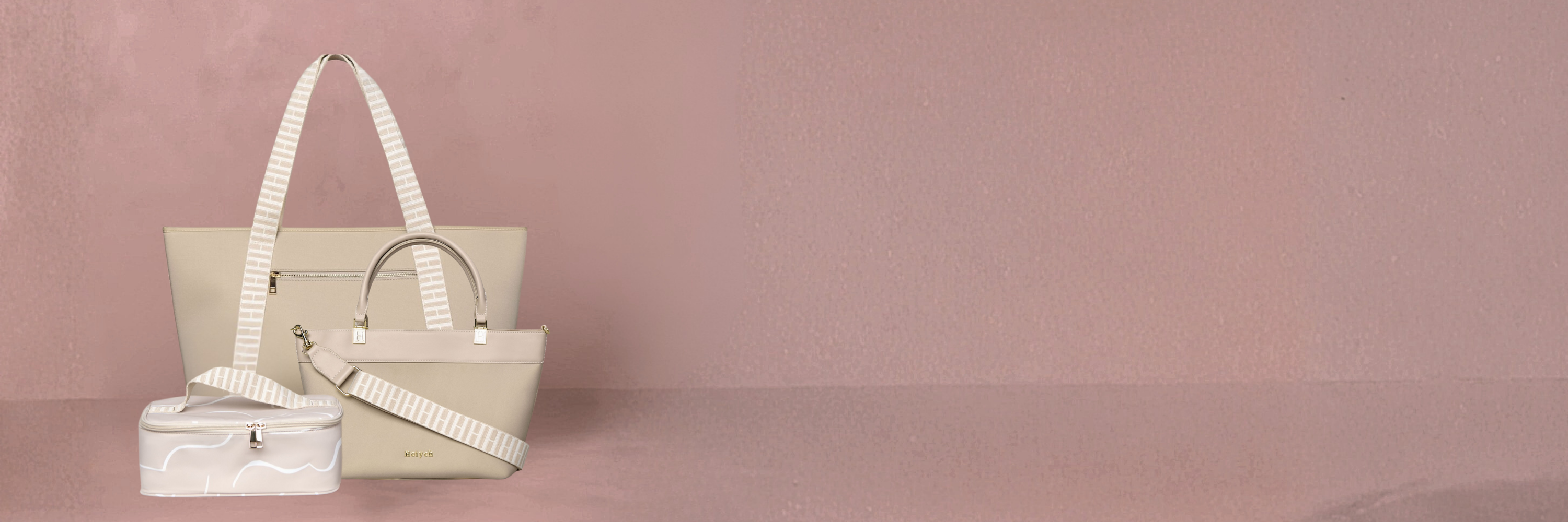 Beige handbag with white strap on a pink background