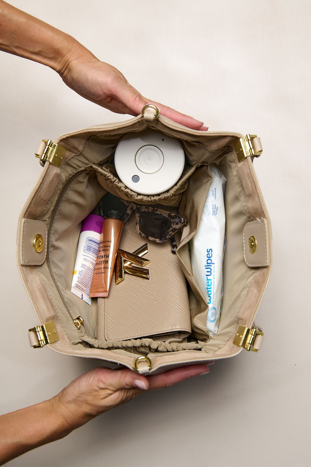 Taupe cream tote bag filled with items 