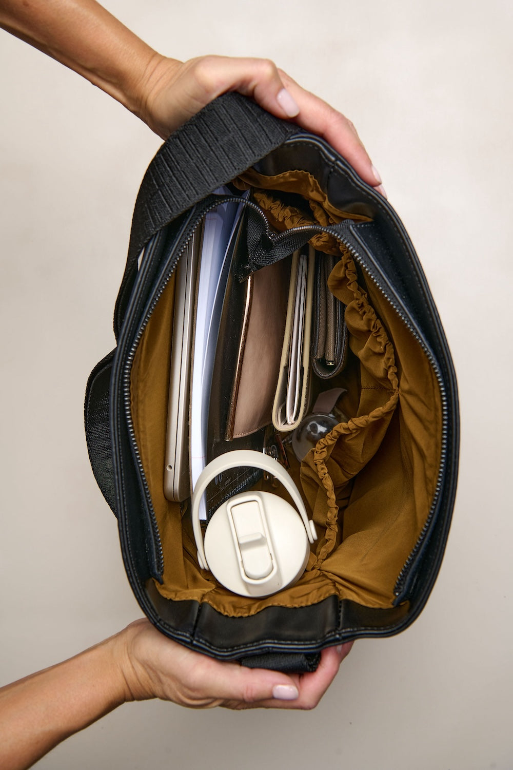 Black bag with laptop and drink bottle inside